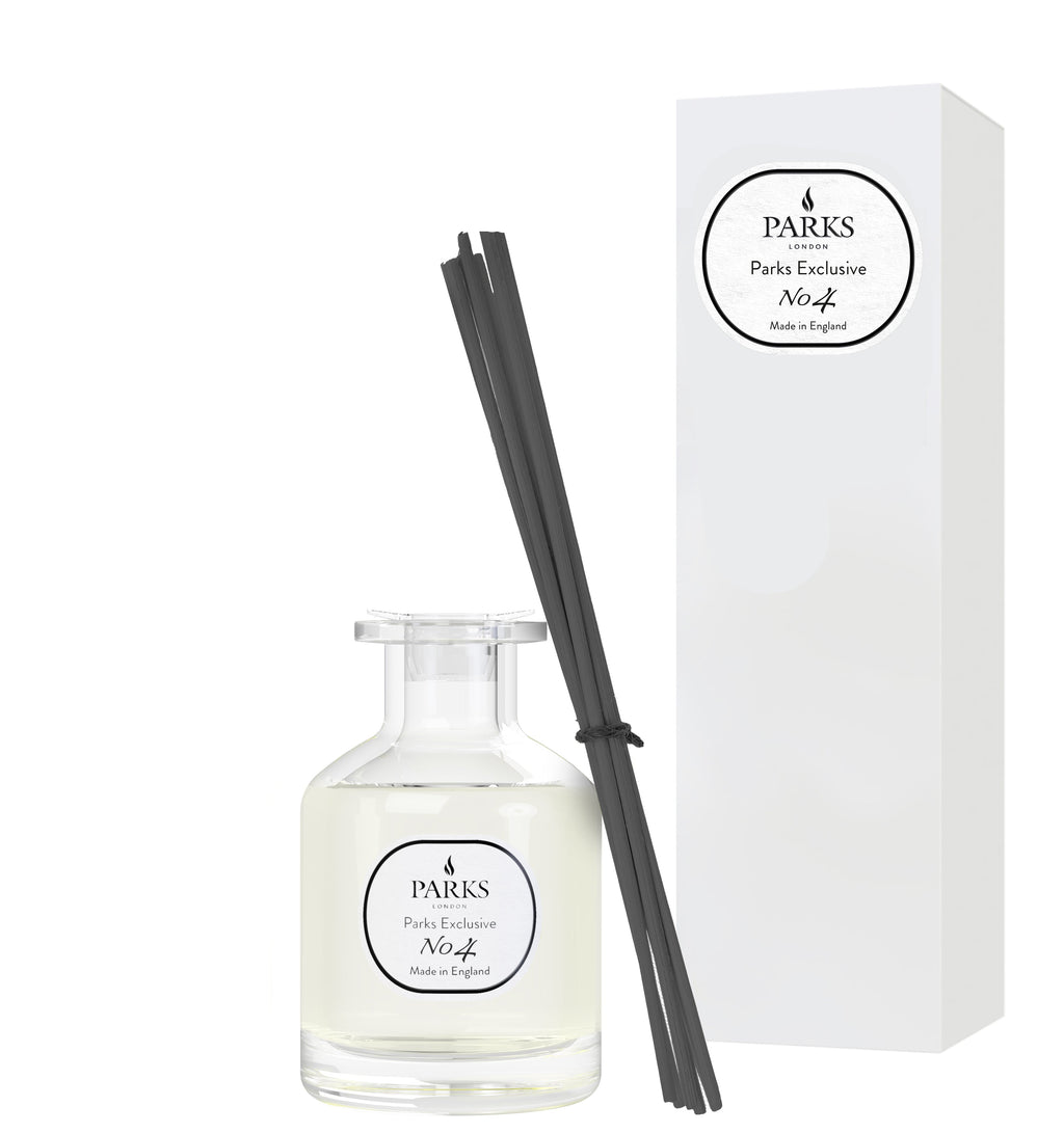 Parks diffuser bottle with black sticks and packaging on a white background