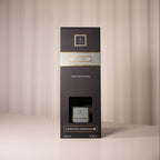 Black packaging box with gold accents on a neutral background
