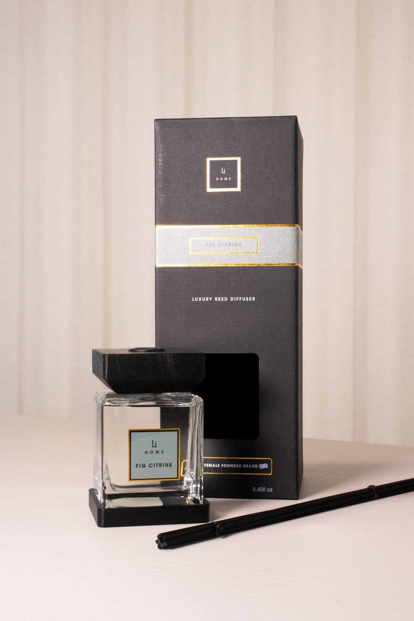 Jo Malone diffuser with packaging and black pen on a beige background