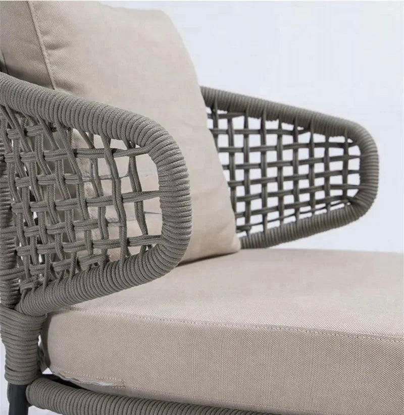 Chair with woven backrest and beige cushion on a white background