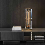 Modern table lamp on a dark wooden surface with a textured black wall background