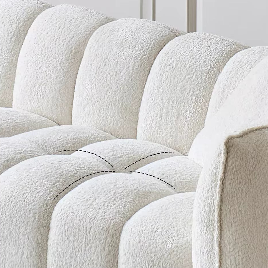 Close-up of a textured white sofa with visible stitching details.
