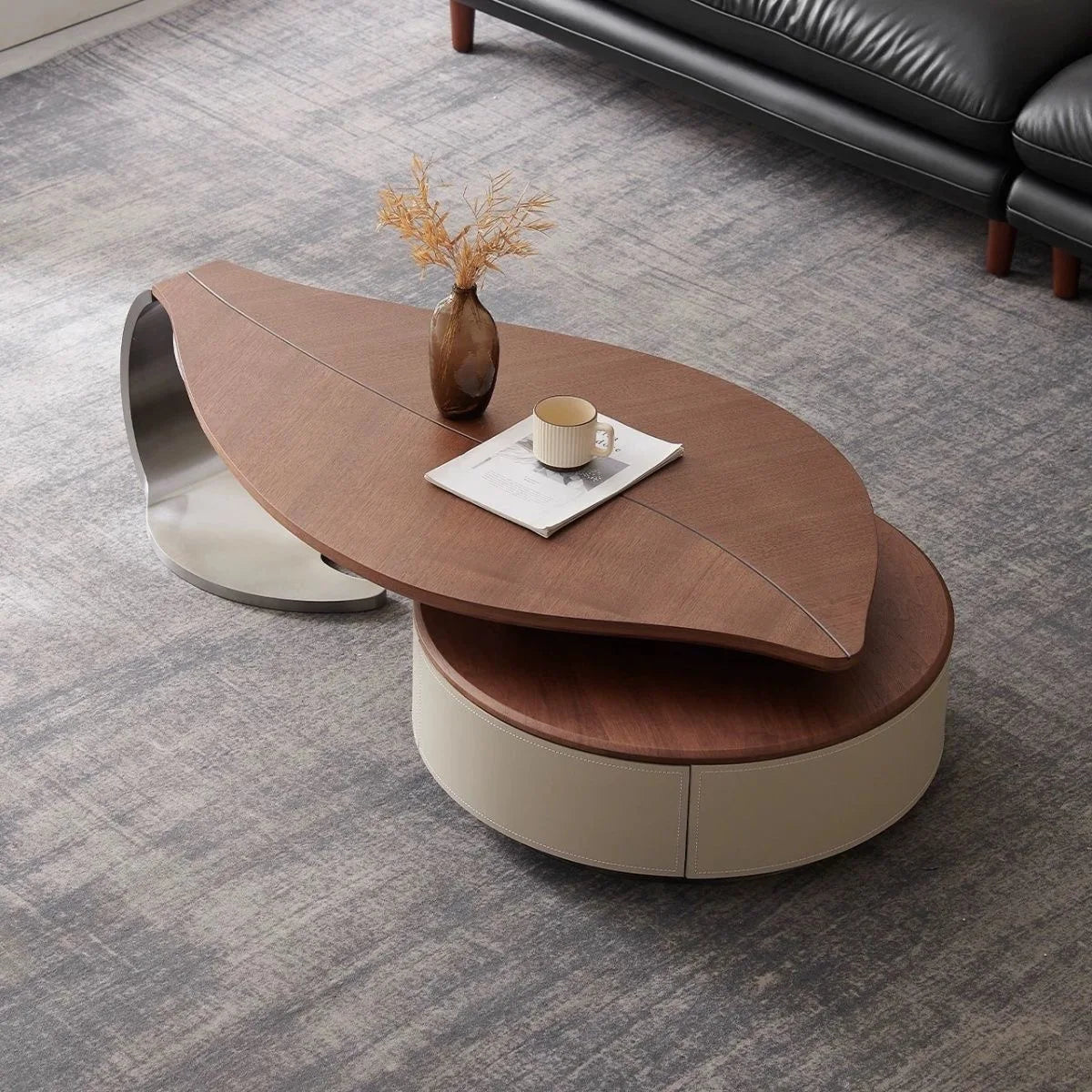 Modern coffee table with a leaf-shaped design in a living room setting.