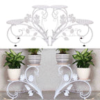 Decorative white metal plant stand with potted plants on a neutral background