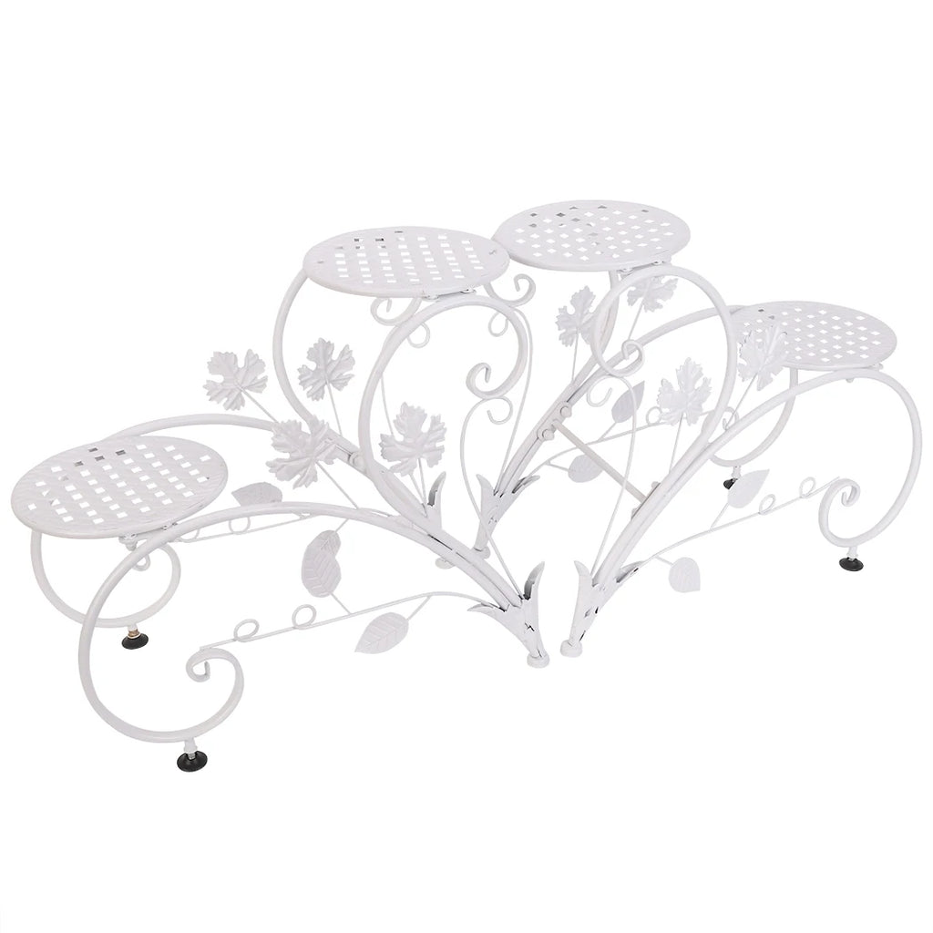 White metal decorative plant stand with floral designs on a white background