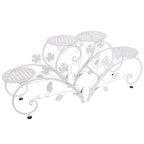 White metal decorative plant stand with floral designs on a white background