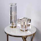 Two modern table lamps on a round marble table with a white background