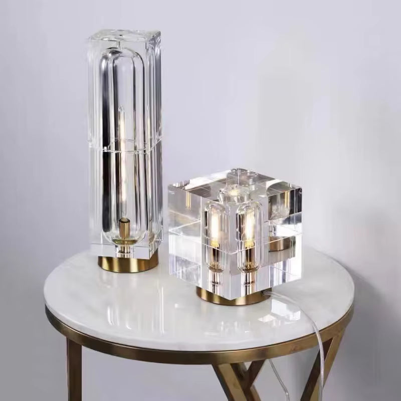 Two modern table lamps on a round marble table with a white background
