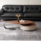 Modern black leather sofa with a stylish wooden coffee table in a living room setting.