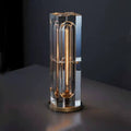 Modern table lamp with crystal base and gold accent on a dark background
