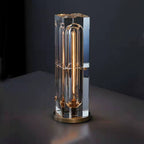 Modern table lamp with crystal base and gold accent on a dark background