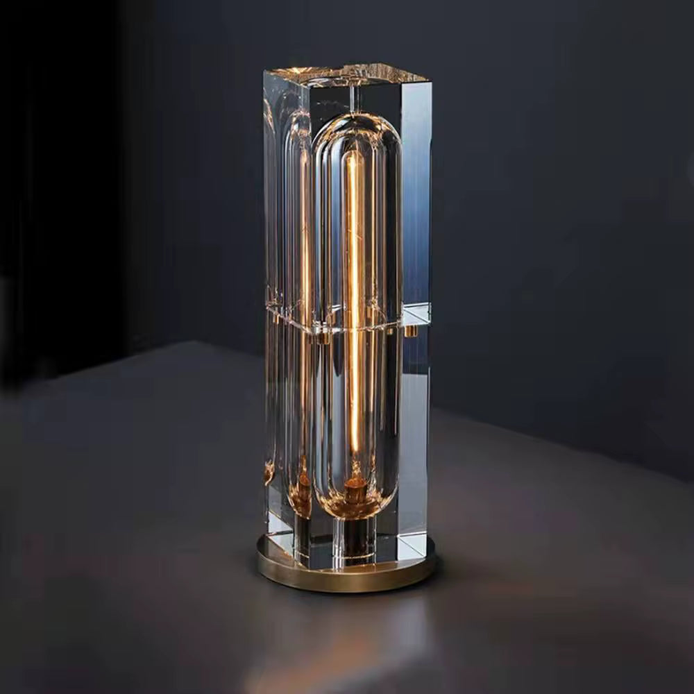 Modern table lamp with crystal base and gold accent on a dark background