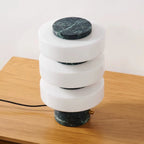 Modern lamp with marble accents on a wooden surface