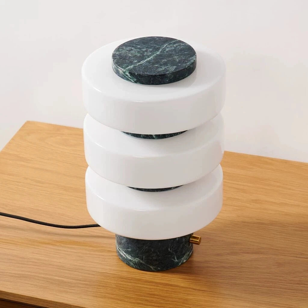 Modern lamp with marble accents on a wooden surface
