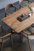 Wooden dining table with chairs in a modern setting