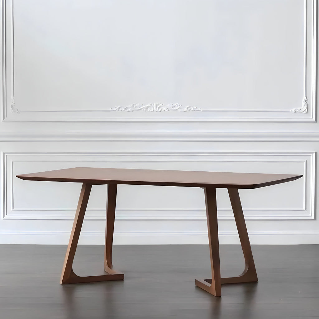 Wooden dining table against a white wall