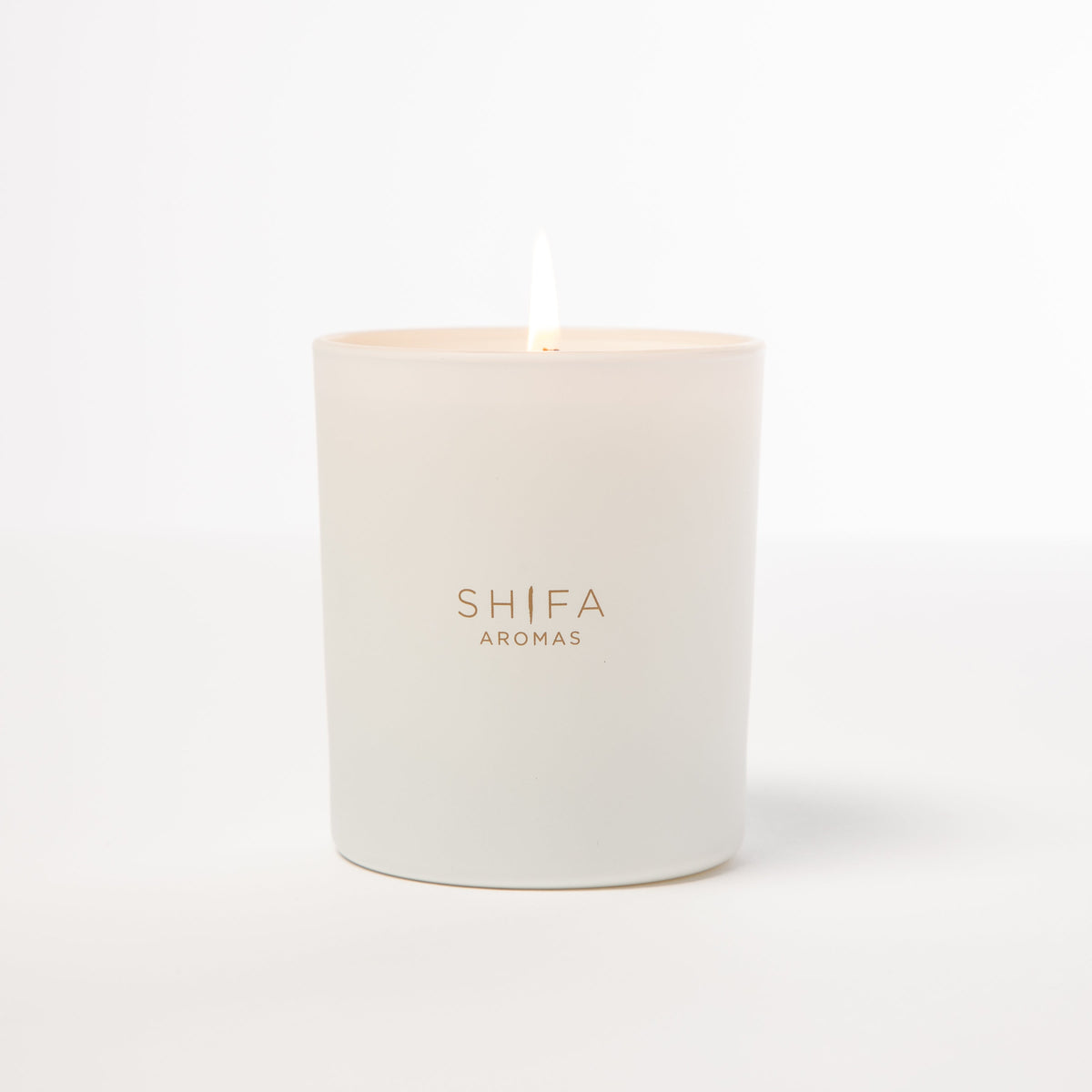 White candle with 'SHIFA AROMAS' branding on a white background