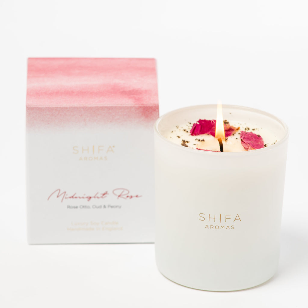 Shifa Aromas candle with rose petals and packaging on a white background