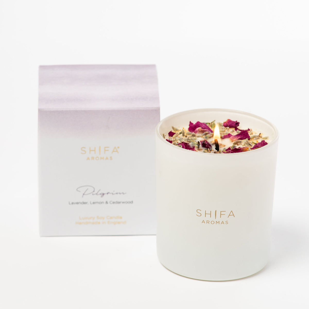 Shifa Aromas candle with floral elements and packaging on a white background
