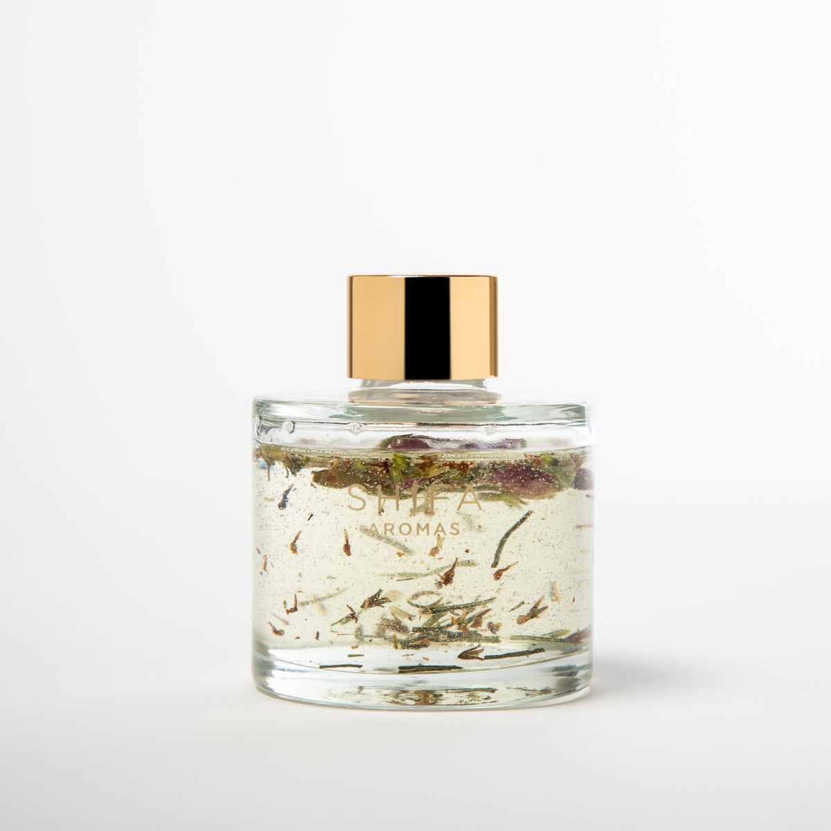 Glass candle with gold lid on a white background