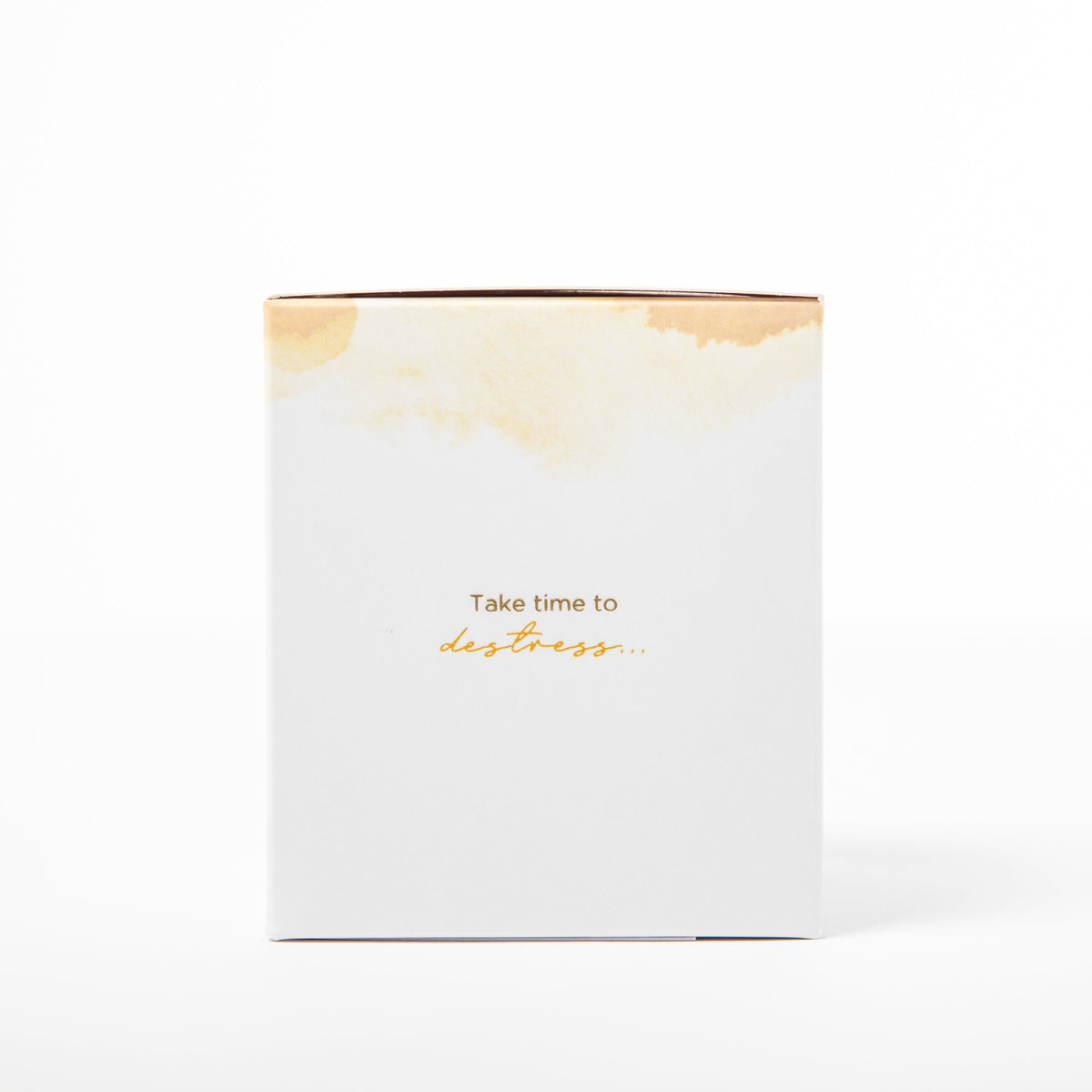 White candle box with gold text and design on a white background