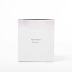 White candle with gold text 'Take time to heal' on a white background