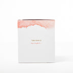 Candle with watercolor design and text 'Take time to escape' on a white background