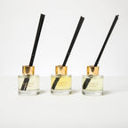 Three Shifa Aromas diffusers with black sticks on a white background