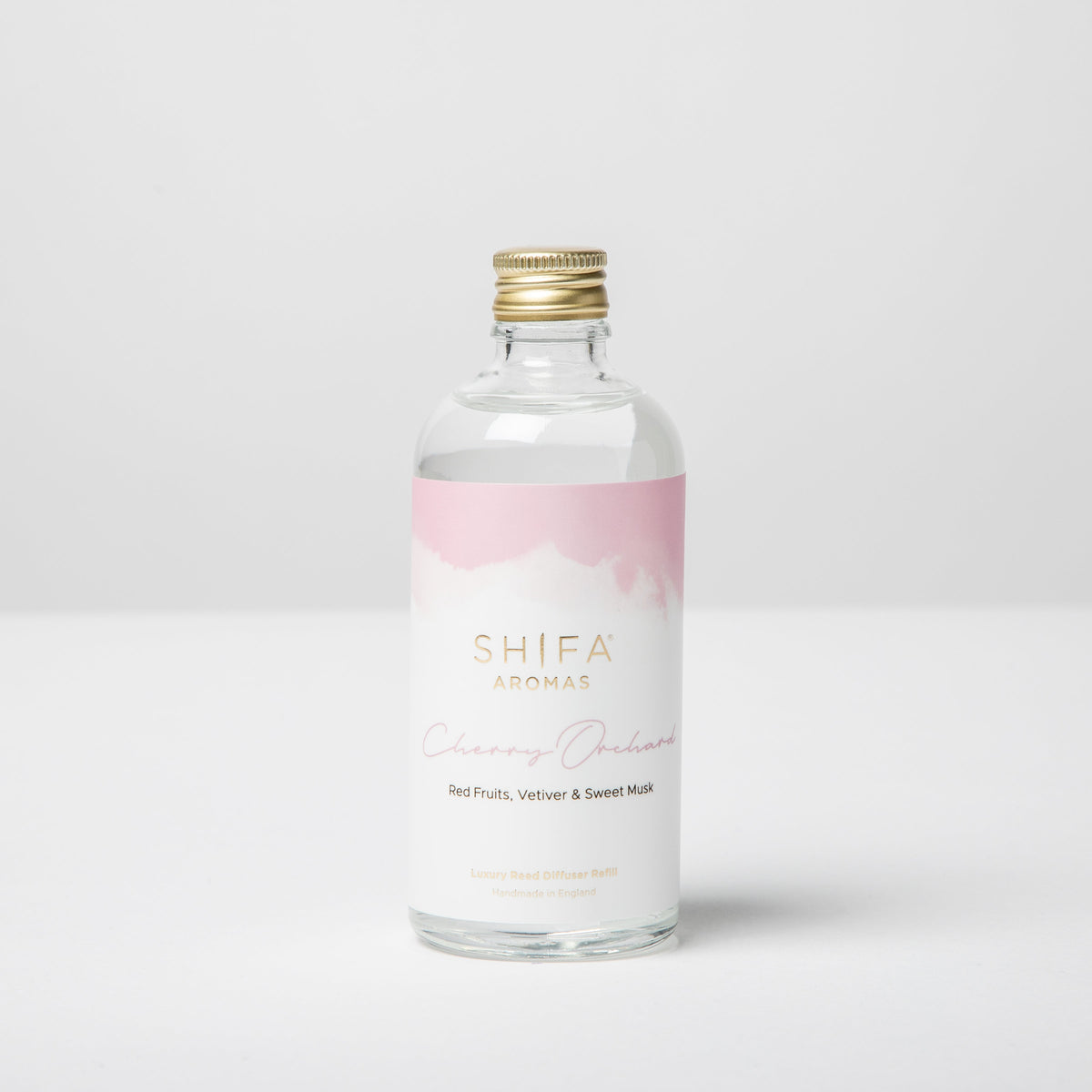 Clear bottle with a pink label on a white background