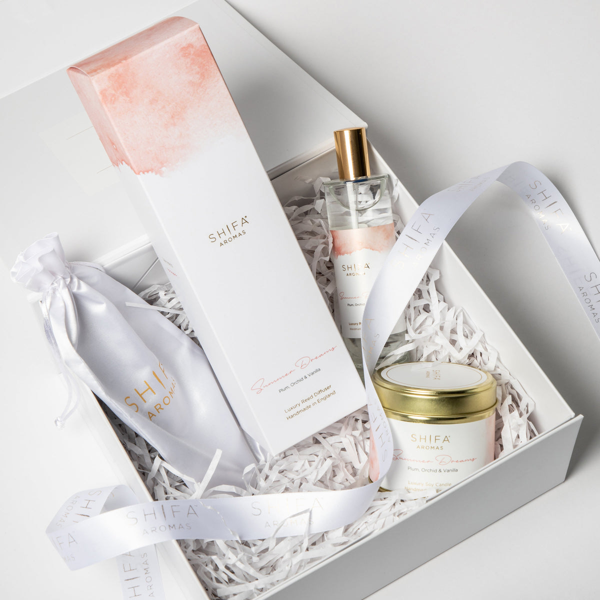 Shea Ambra gift set with products in a box on a light gray background