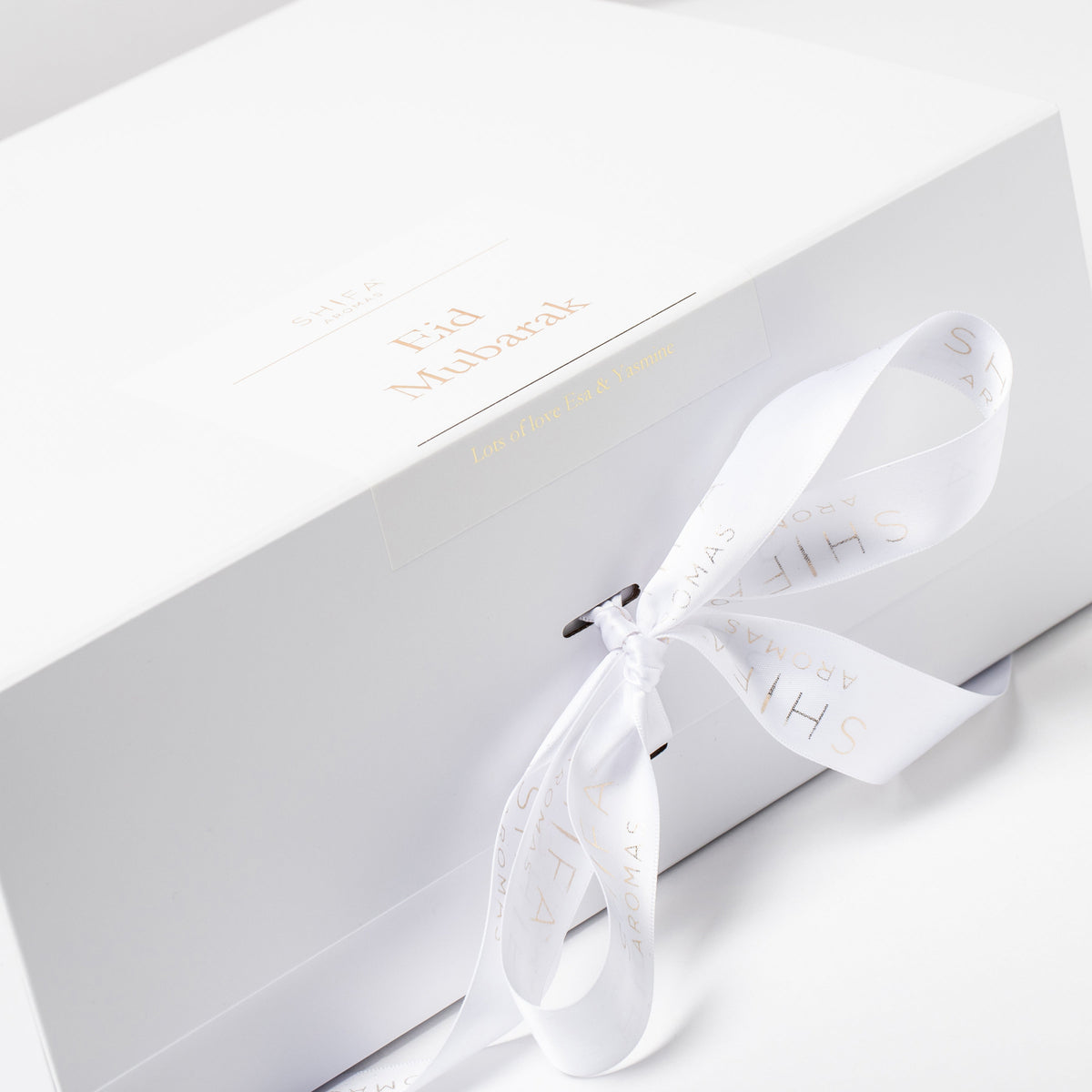 White hair tie with brand name on a white box