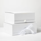 White shoe box with a white sock on a white background