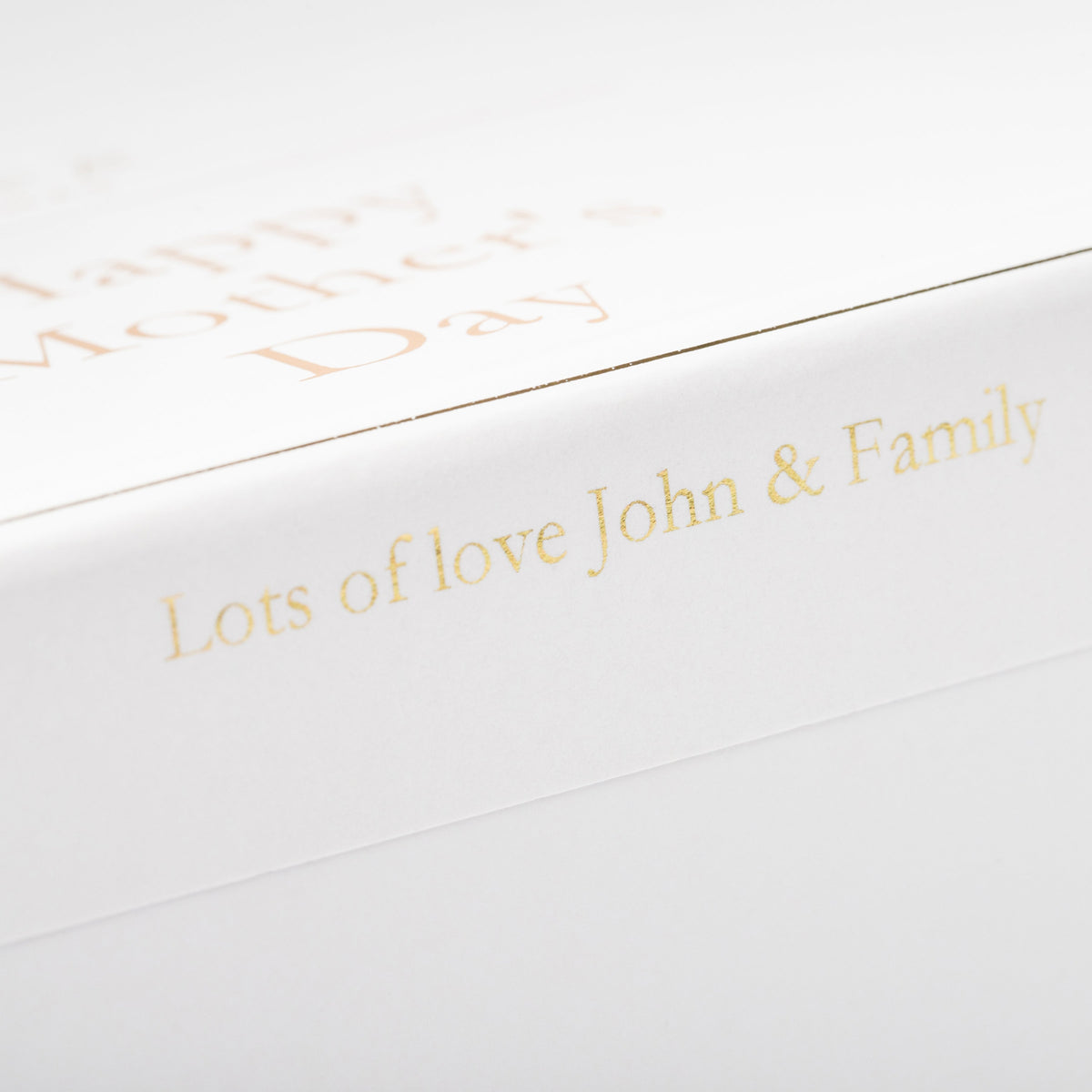 White card with gold text 'Lots of love John & Family' on a white background