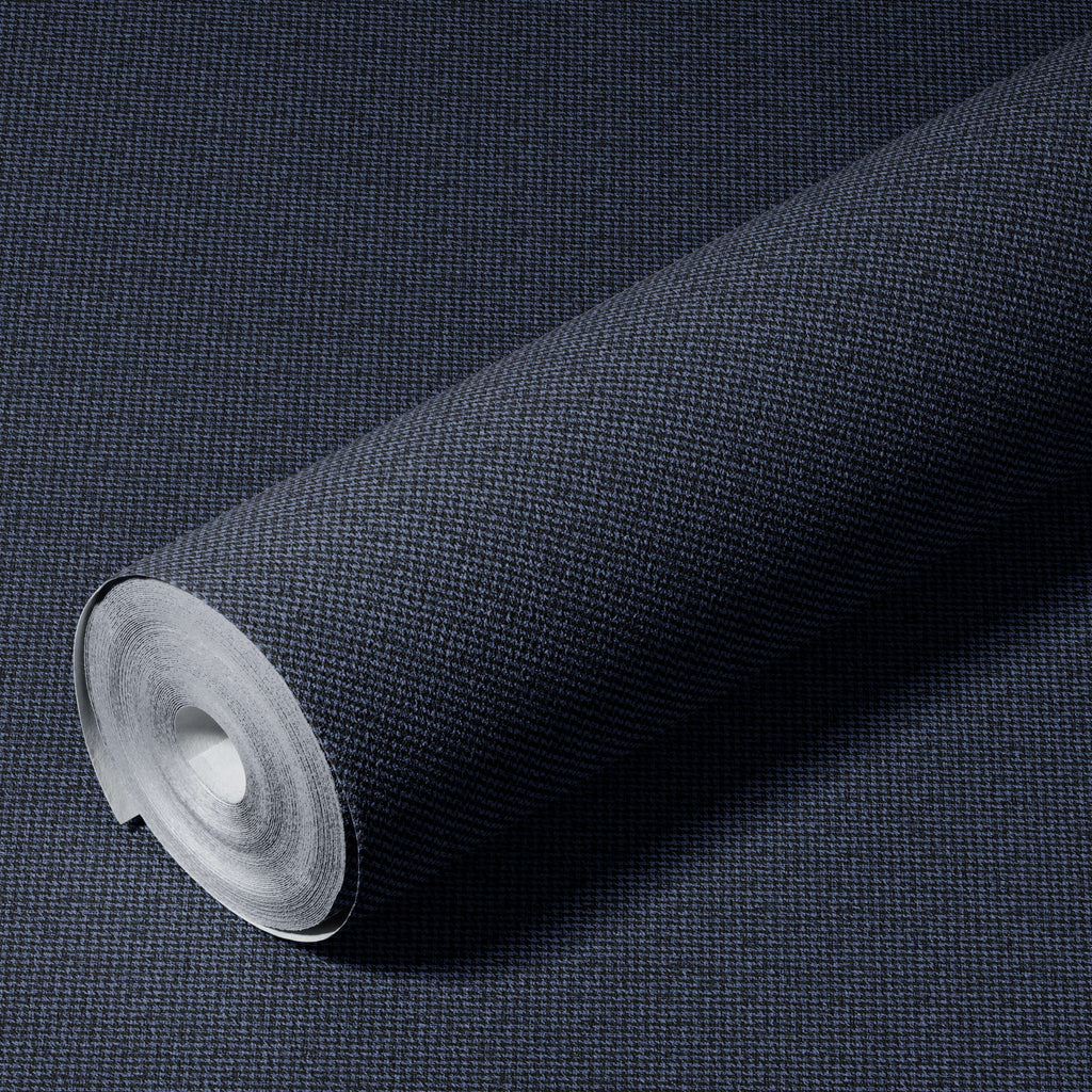 Roll of dark blue textured wallpaper on a matching background