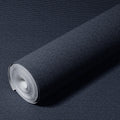 Roll of dark blue textured wallpaper on a matching background