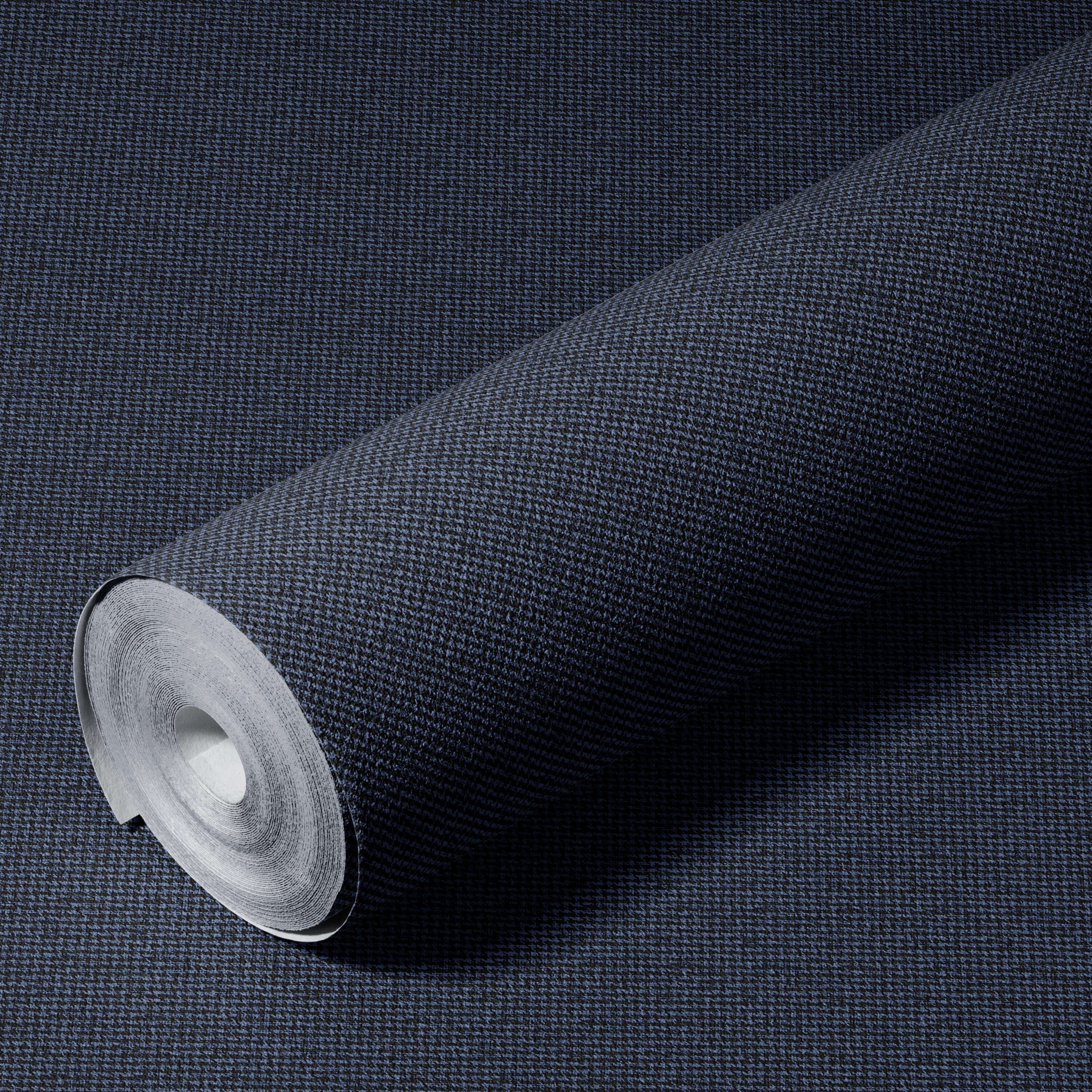 Roll of dark blue textured wallpaper on a matching background
