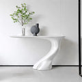 Modern white dining table with a vase and plant in a minimalistic setting