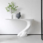 Modern white dining table with a vase and plant in a minimalistic setting