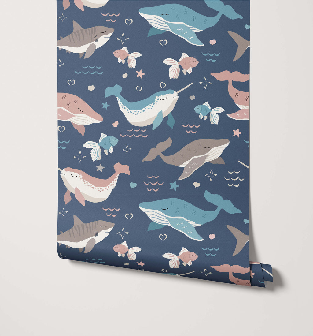 Roll of wallpaper with whale and fish pattern on a blue background