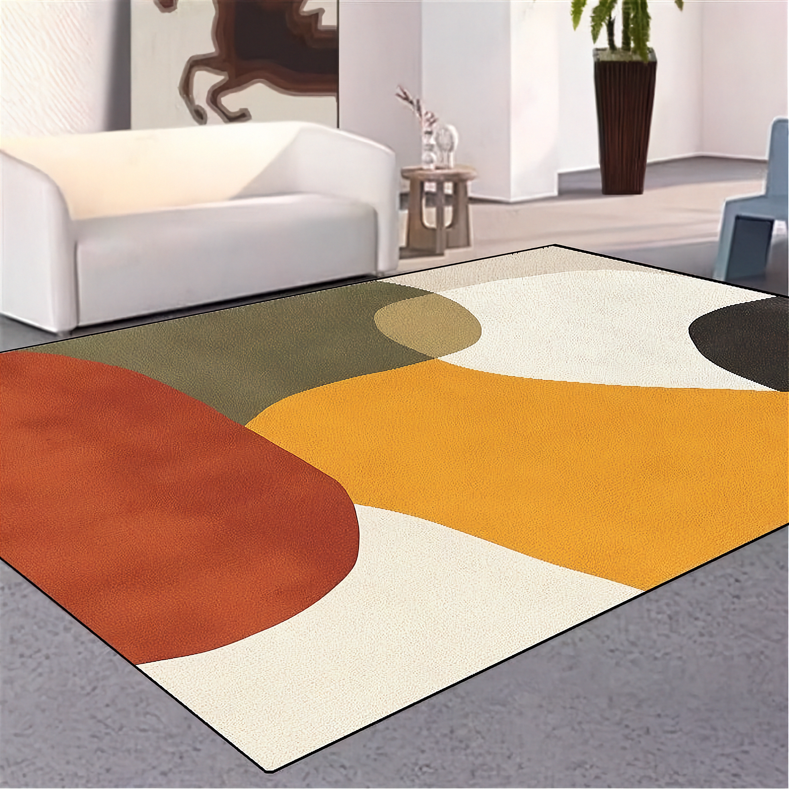 Colorful abstract rug on a gray floor with a white wall and furniture in the background