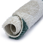 Rolled-up rug with textured surface on a white background