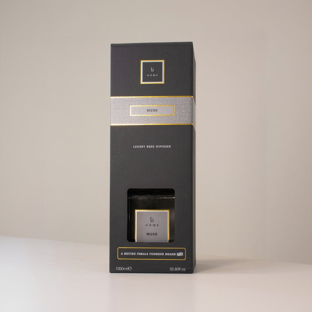 Black packaging box with gold accents on a beige background