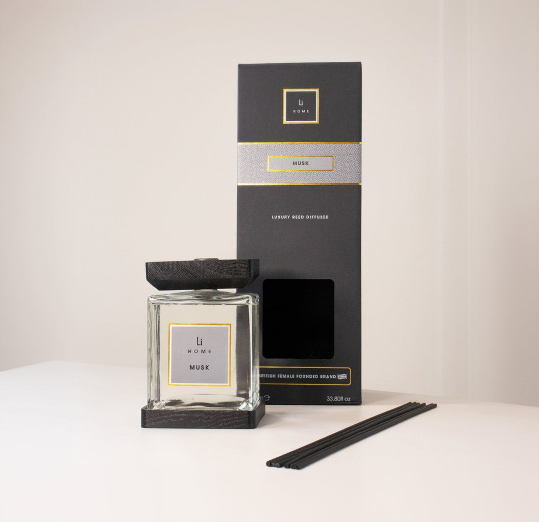 Scented candle and packaging with brand logo on a neutral background