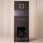 Black box with gold and blue accents on a beige background