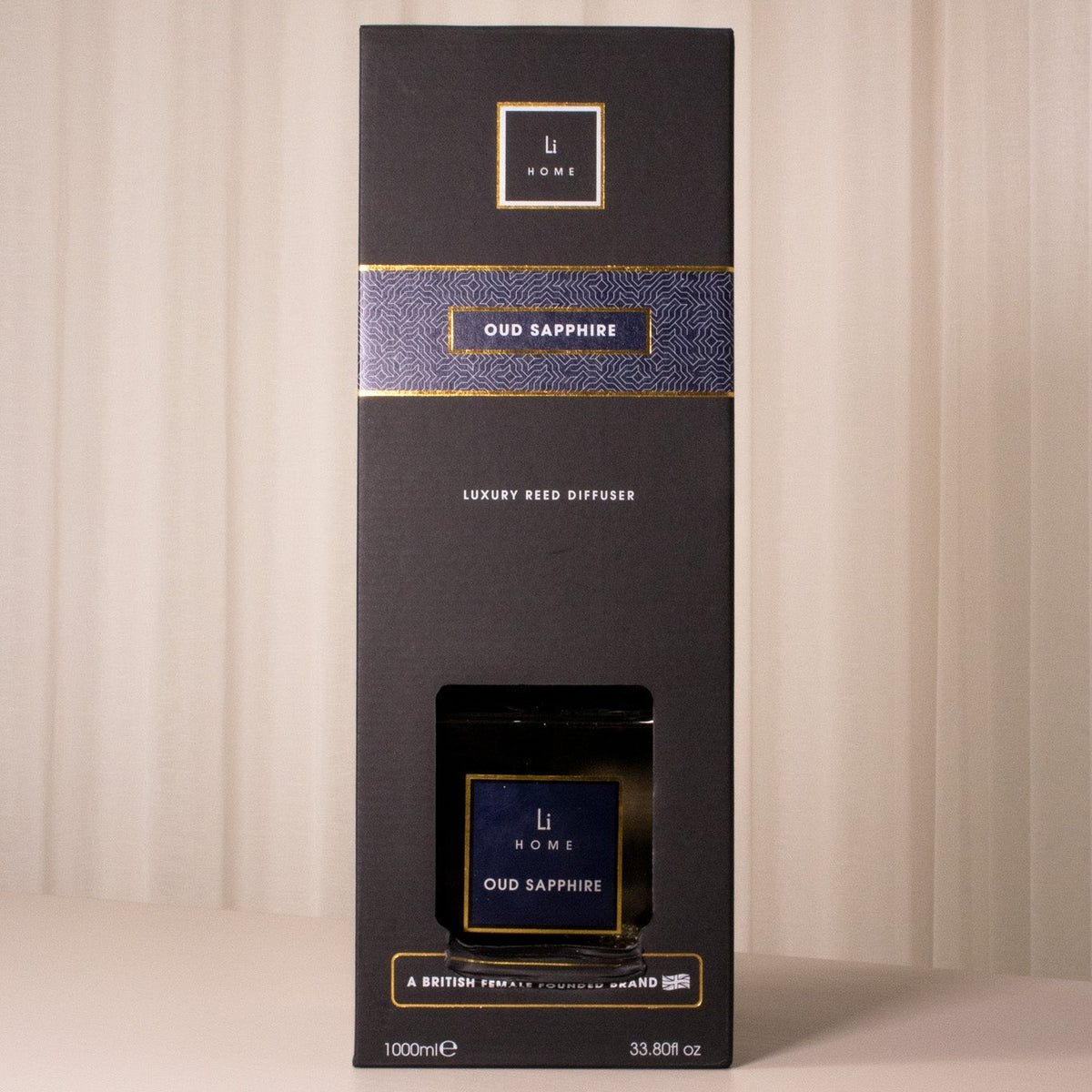 Black box with gold and blue accents on a beige background