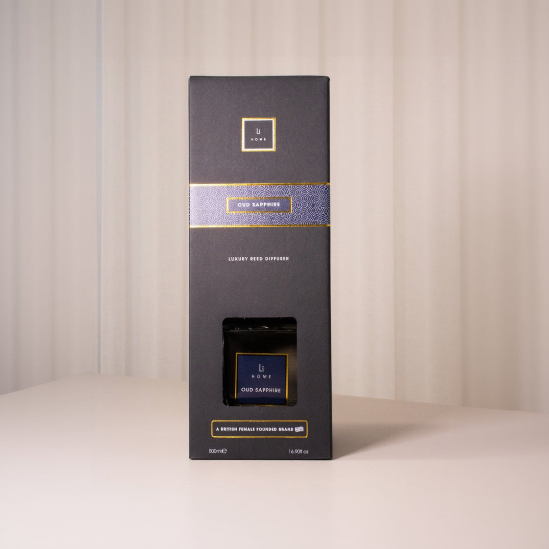 Dark gray packaging box with gold accents on a light background