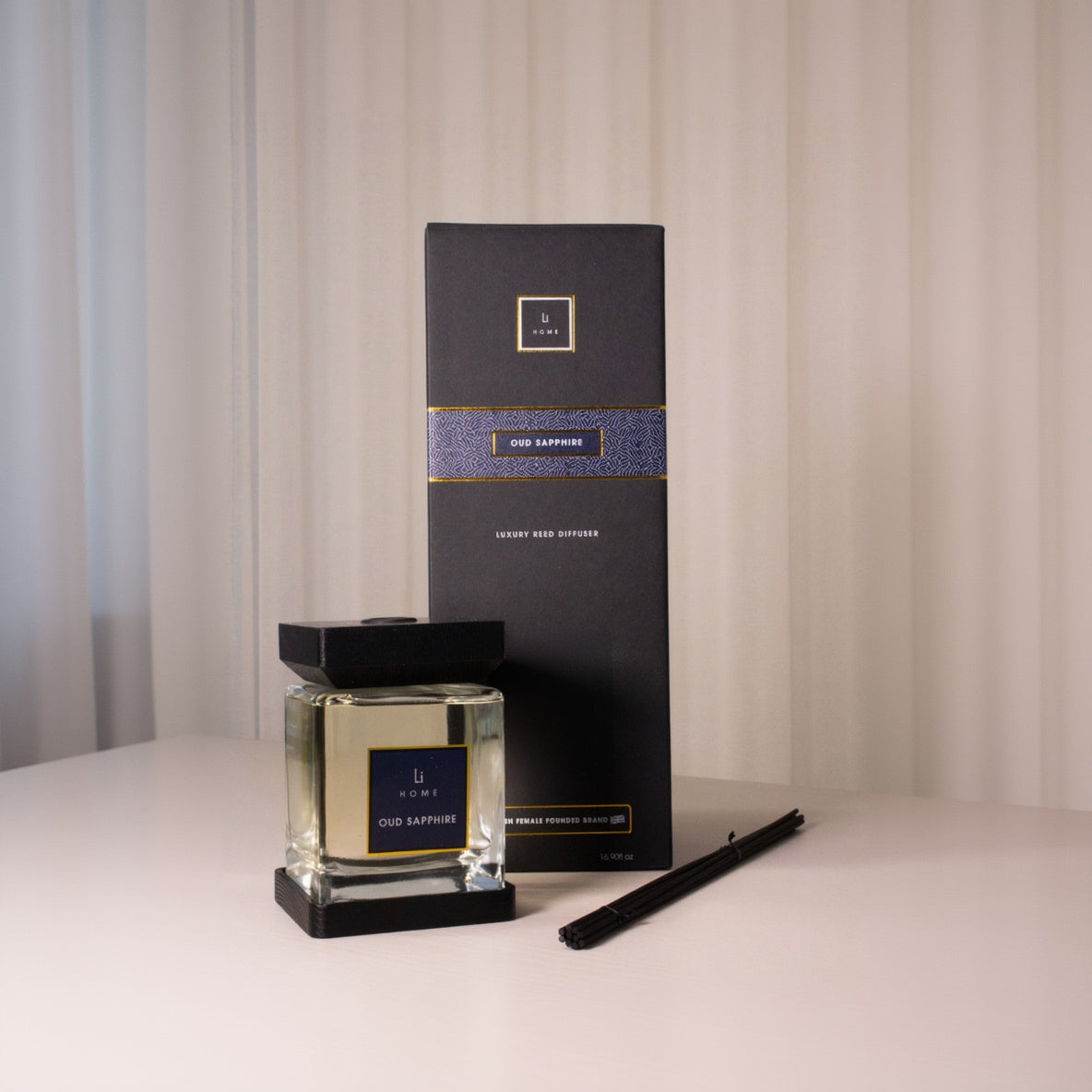 Oud Sapphire diffuser with packaging on a neutral background