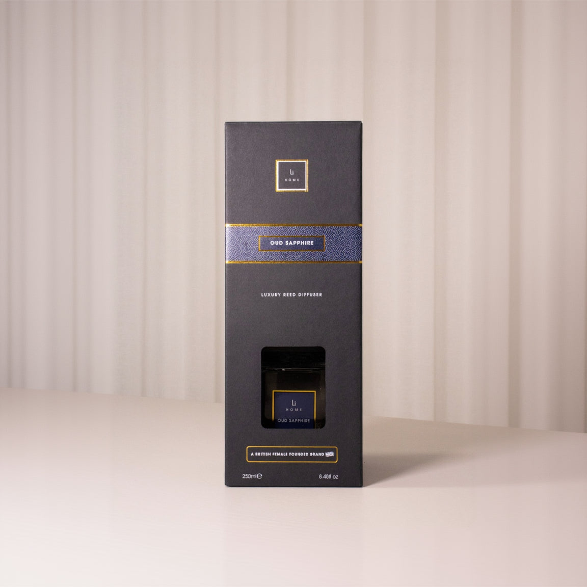 Dark gray box with gold accents on a beige background