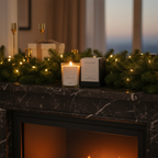 Decorative setup with a candle, calendar, and greenery on a mantelpiece in front of a fireplace.