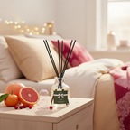 Diffuser with sticks on a table in a cozy living room setting